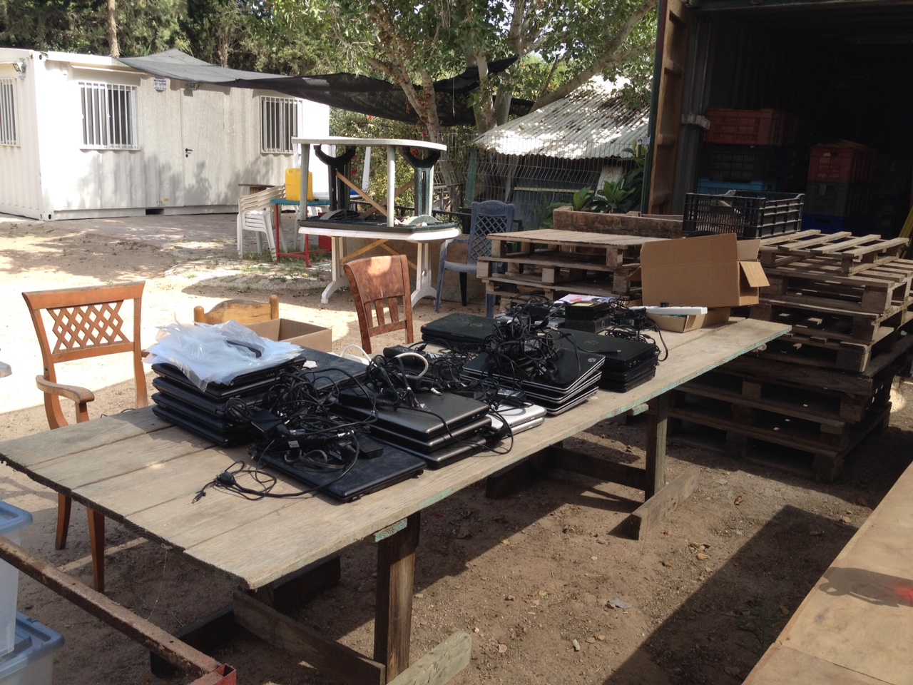 Table of sorted computers with the second mobile office in the background
