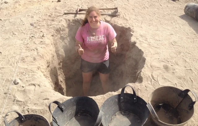 Emily stands in the hole she dug. Today
