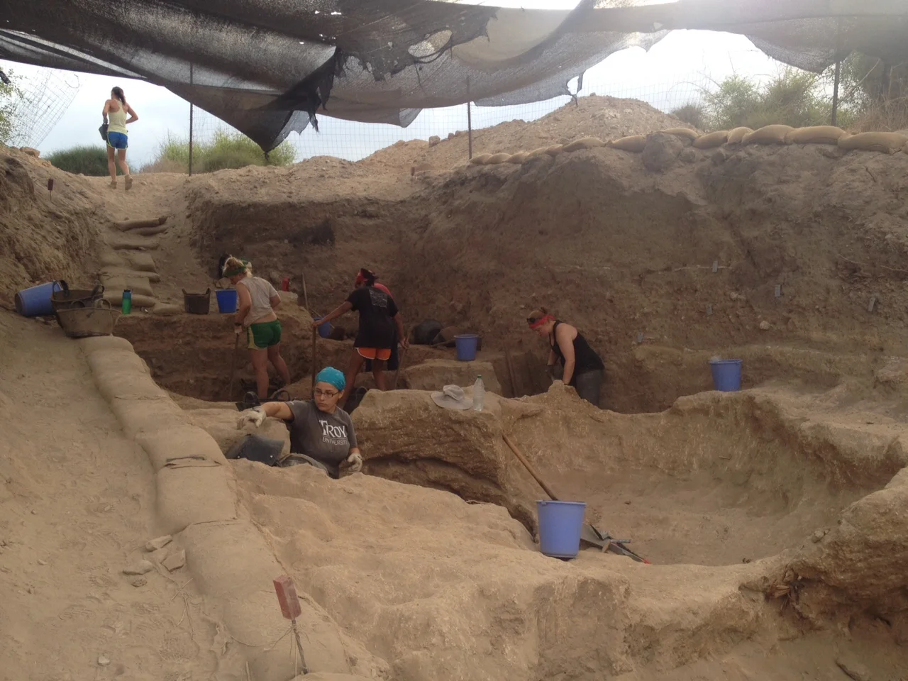 Digging pits cut into the Grid 16 mudbrick wall.