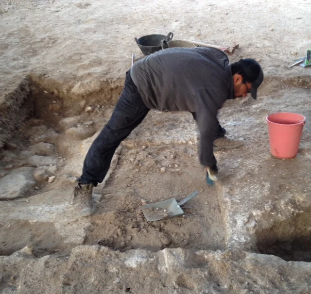 Jamaal does some stretching while excavating