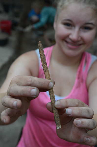 Whitney holding a piece of carved bone