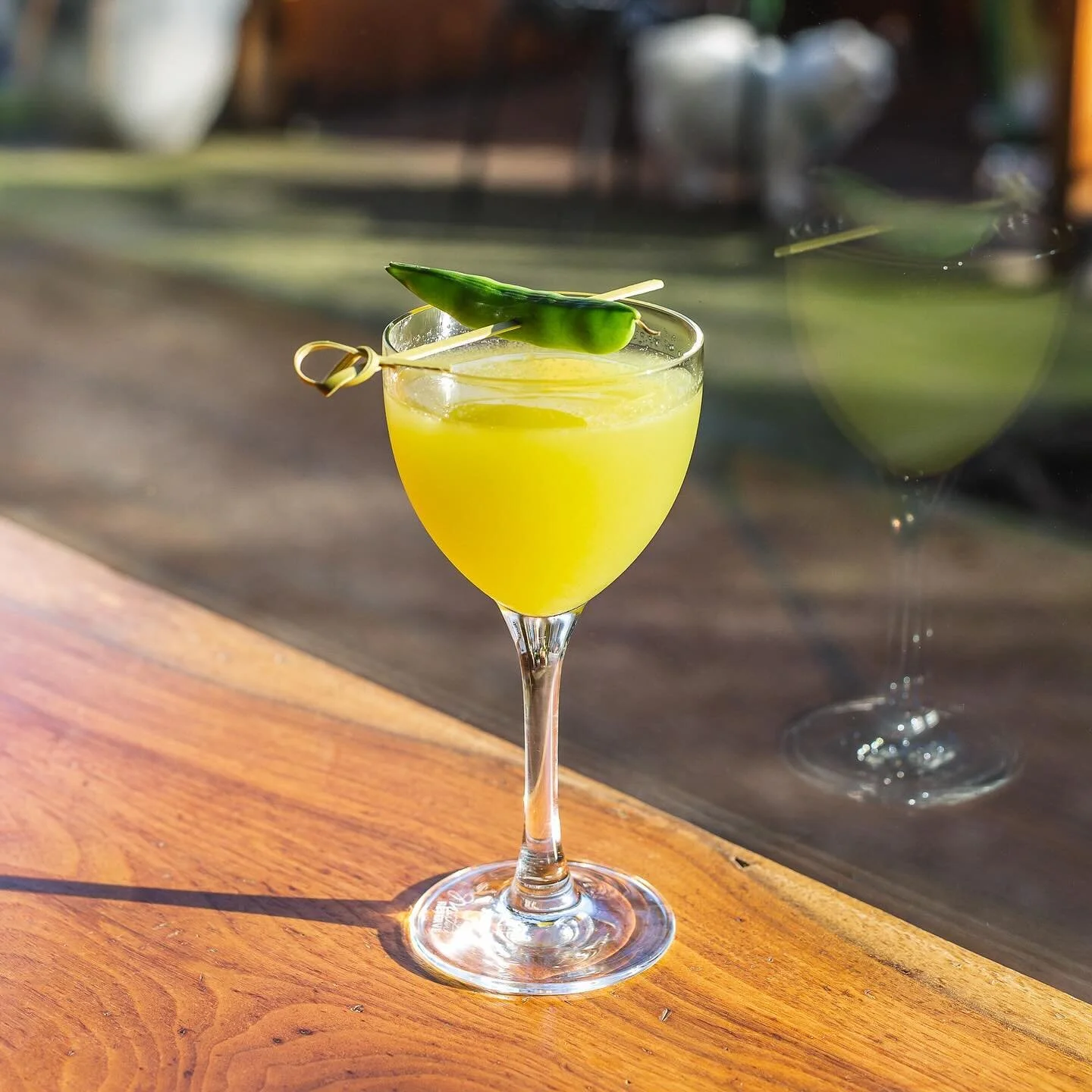 ☀️ Sunshine in a glass! Our new cocktail Chaparr&oacute;n is a burst of cheer&mdash;a blend of Cachaca, Plantation Pineapple, Smith &amp; Cross, and Lemon. Adorned with a little snap pea sure to bring a smile to all who see it. Enjoy it for brunch, h