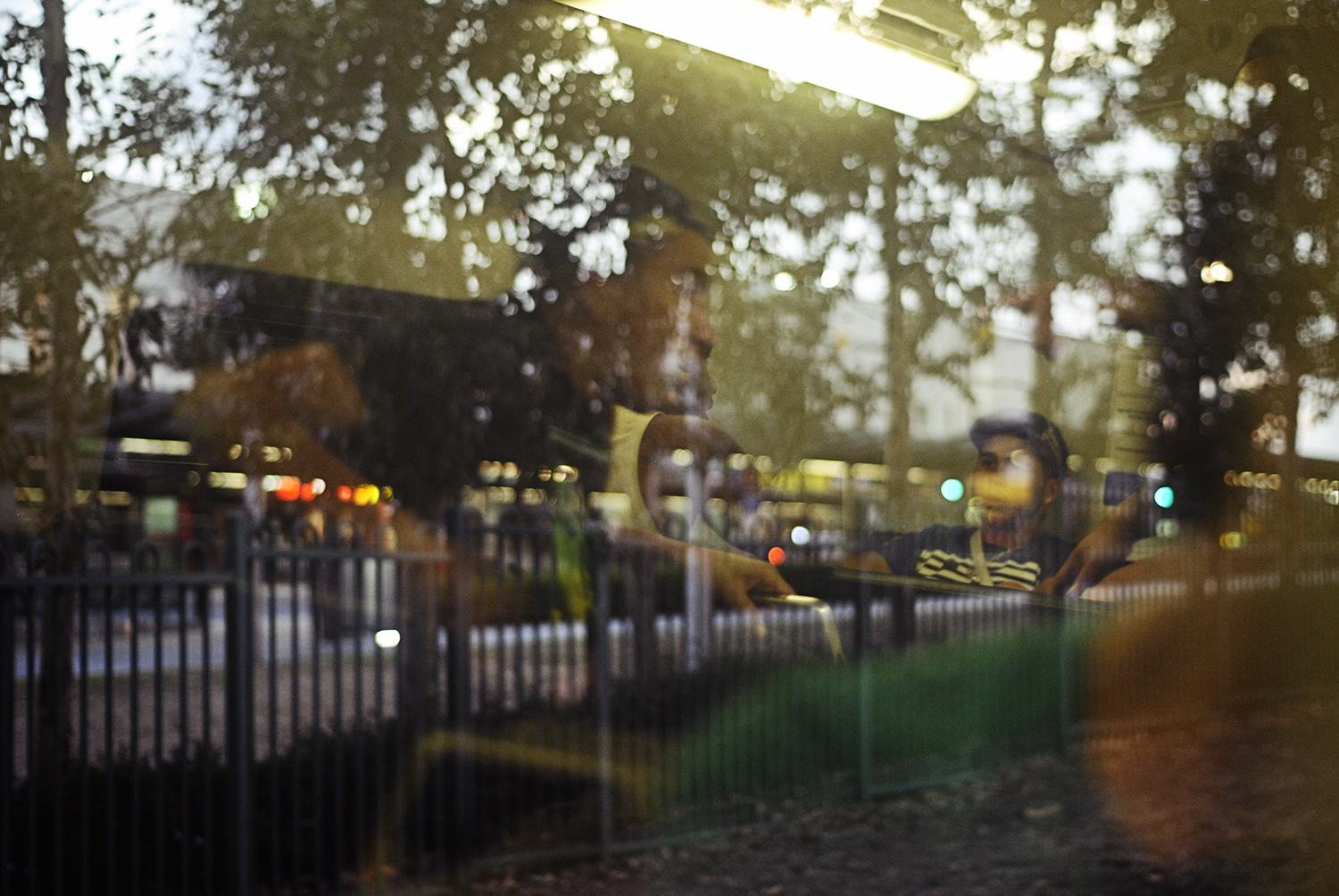 the beginnings of a fight through the train's window reflection