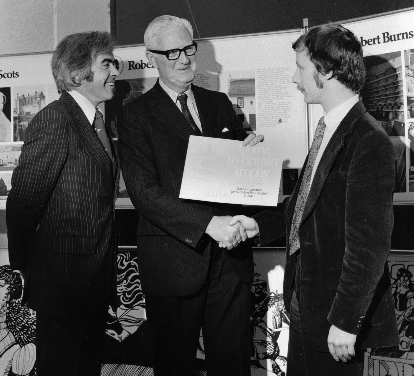 34_Robin MacLellan presents John Cairney and Colin Harvey Wright with the 'Come to Britain' award 1976.jpg