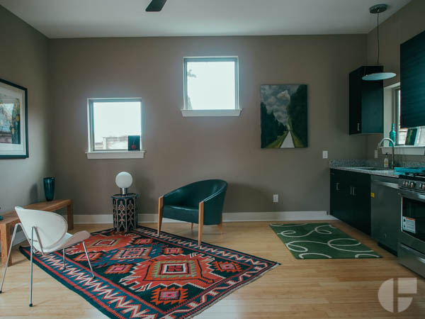  The entire first floor is public space. A simple kitchen / living room, a full bathroom, and french doors that open out to a covered patio.&nbsp; 