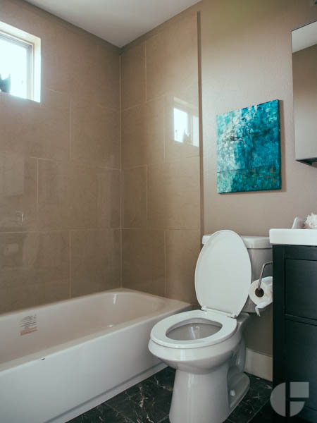 The upstairs has two small bedrooms, one with a full bathroom, and another covered patio. This one with city views. 