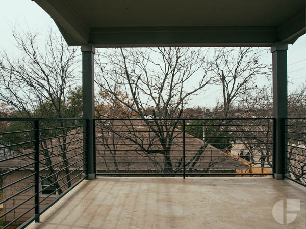 The upstairs has two small bedrooms, one with a full bathroom, and another covered patio. This one with city views. 