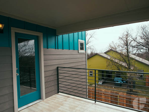 The upstairs has two small bedrooms, one with a full bathroom, and another covered patio. This one with city views. 