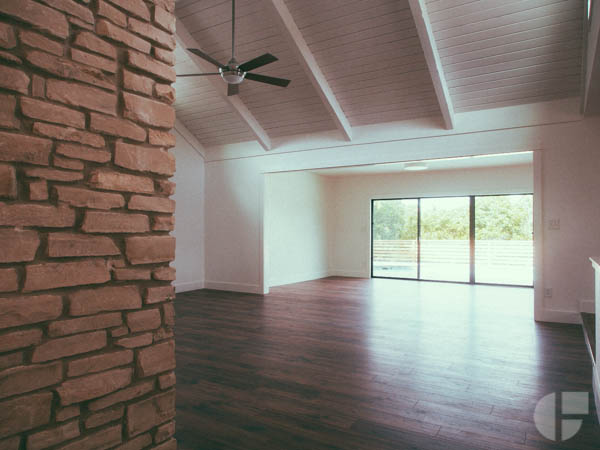 View from the front door looking into the living room. Glass doors open to the pool out back.