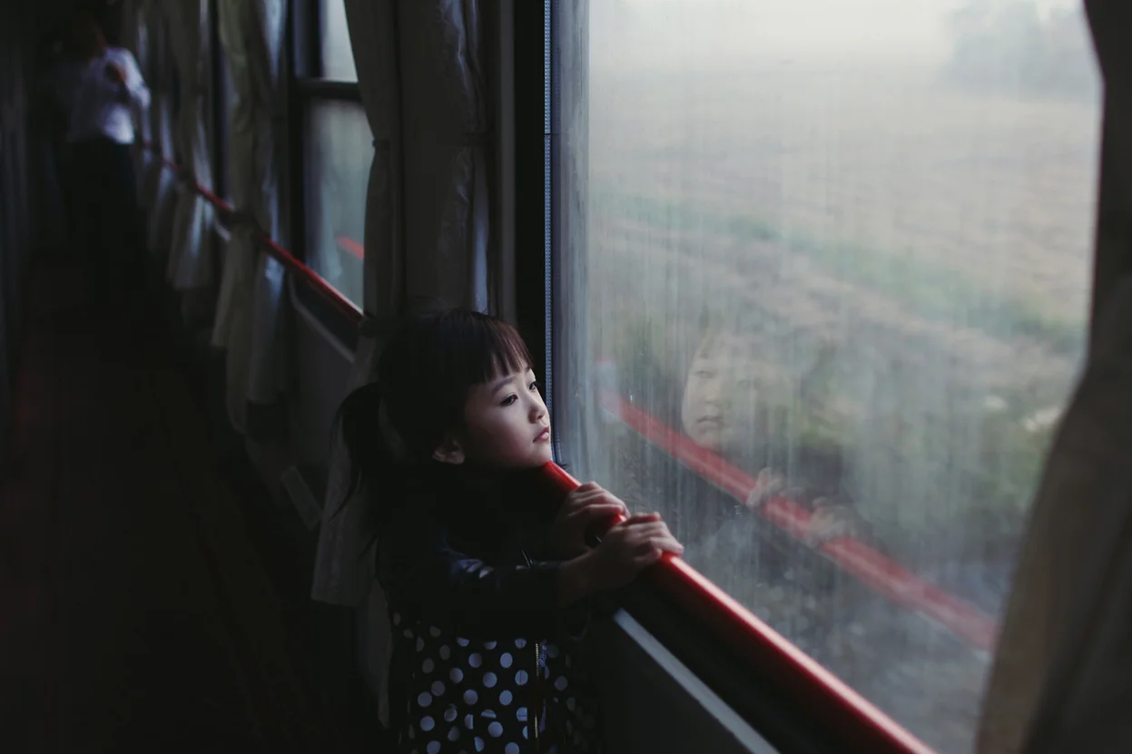 Winner, Youth, Portraits: The photograph was taken during my journey to China in November 2013 with my best friend. The photograph was taken while we were on a night train. We stayed there for 24 hours, so I was in a confined space for a quite limited amount of time. I got up early in the morning to get out and to capture the atmosphere you could find amongst the travelers. And then I found that girl who attracted my attention from the very first moment I saw her. Somehow, she perfectly conveyed a sense of the atmosphere that was present amongst the many travelers on the train. Most of them were waiting eagerly to reach their individual destinations, many of them looking out of the window and watching the world pass by as the train sped through the country, completely captivated by the landscape flying by. (© Paulina Metzscher, 2014 Sony World Photography Awards)