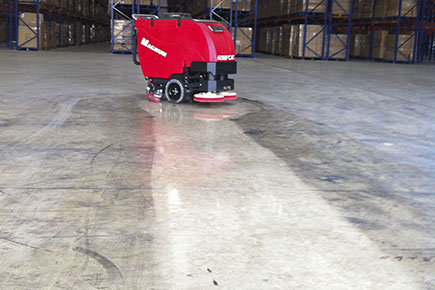 magnum-walk-behind-floor-scrubber-cleaning-and-polishing-concrete-floor-in-warehouse.jpg