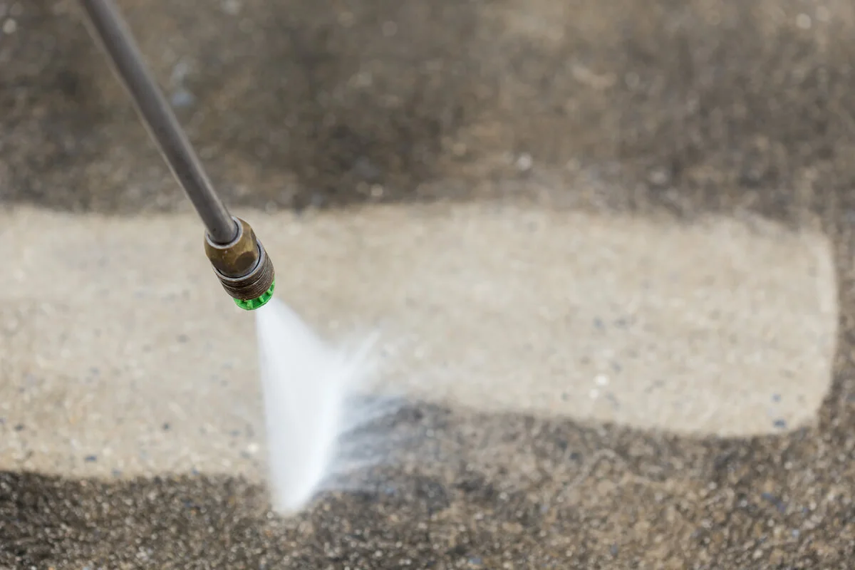 pressure washing sidewalk or driveway to rid of moss, algae, or dirt