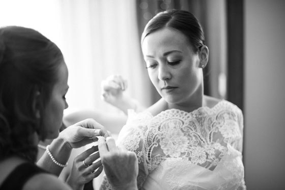 Bridesmaid helping the bride get ready - Jeff Sampson Photography