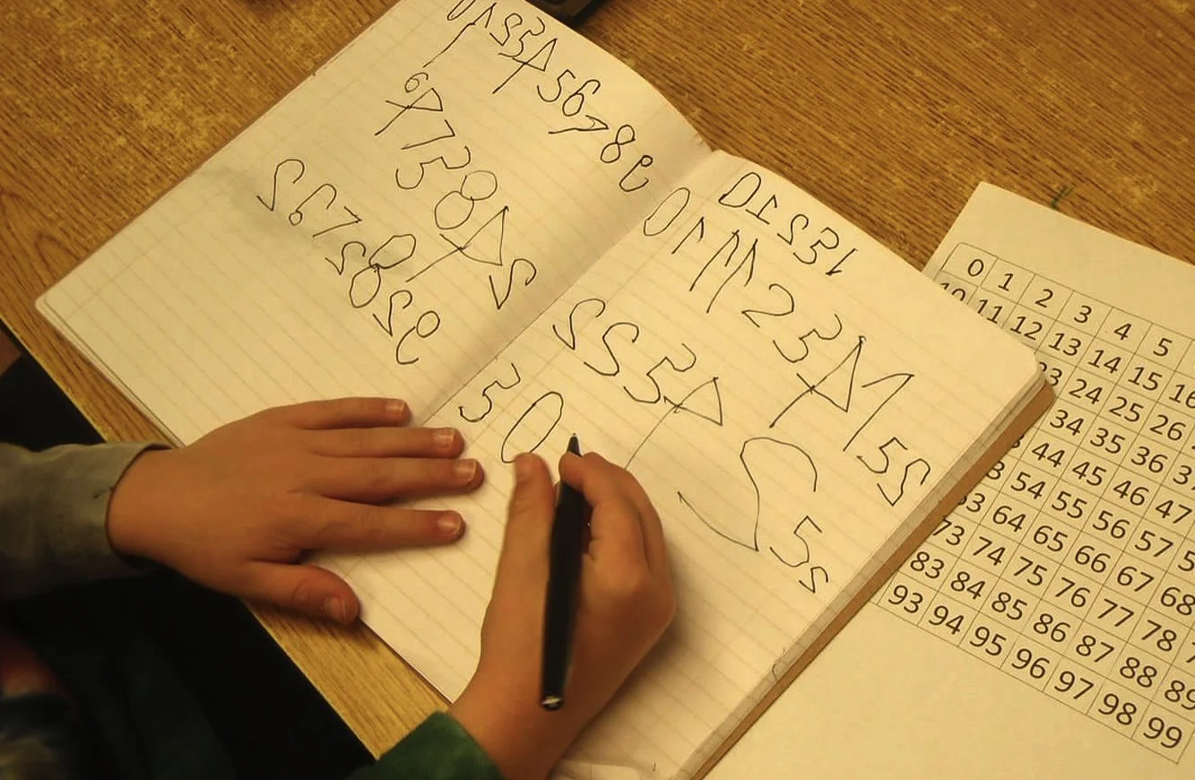 It is common for kids to reverse numbers and letters at first, they grow out of it.