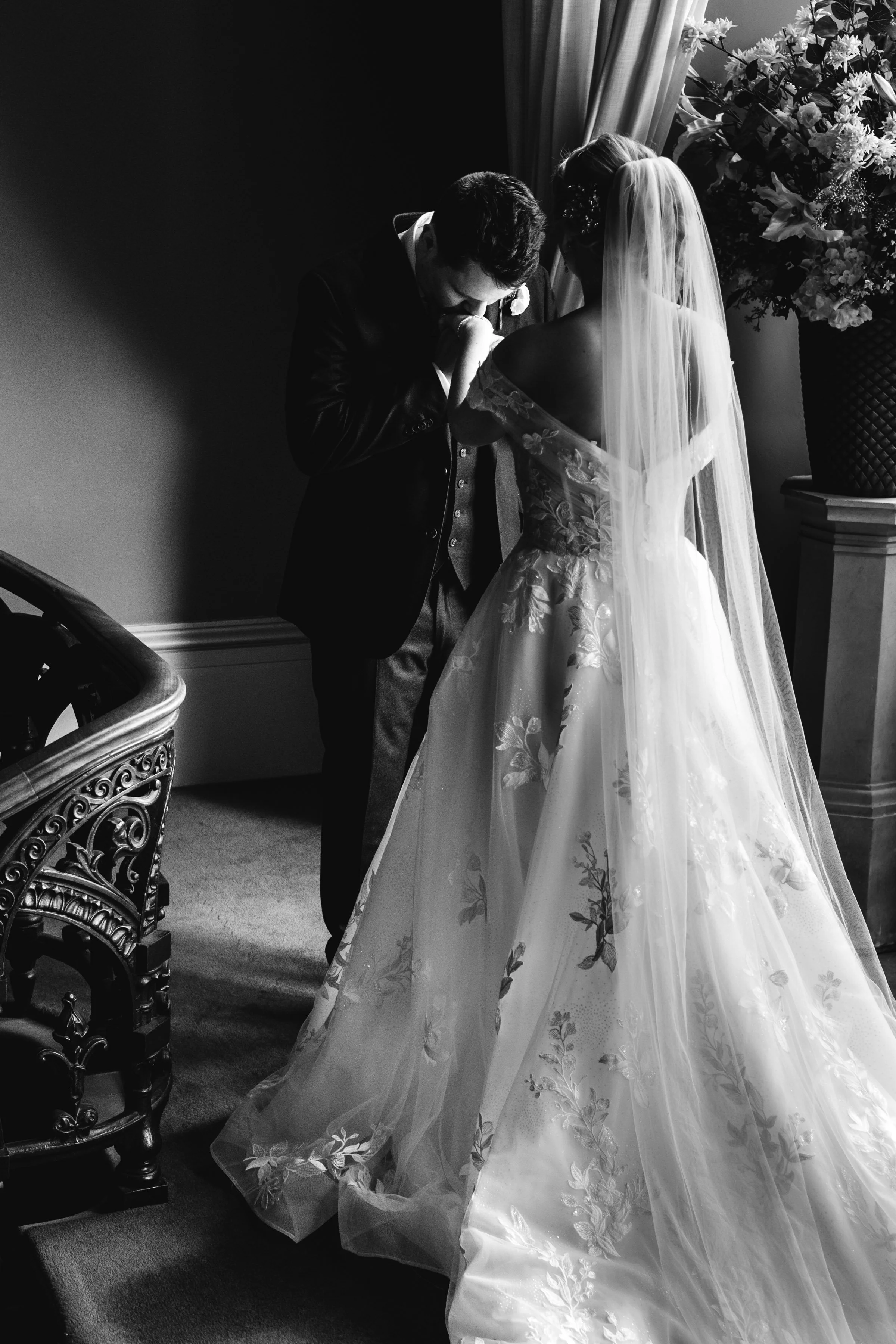 Stopping on the stairs at Grittleton House - The bride and groom share an quiet moment