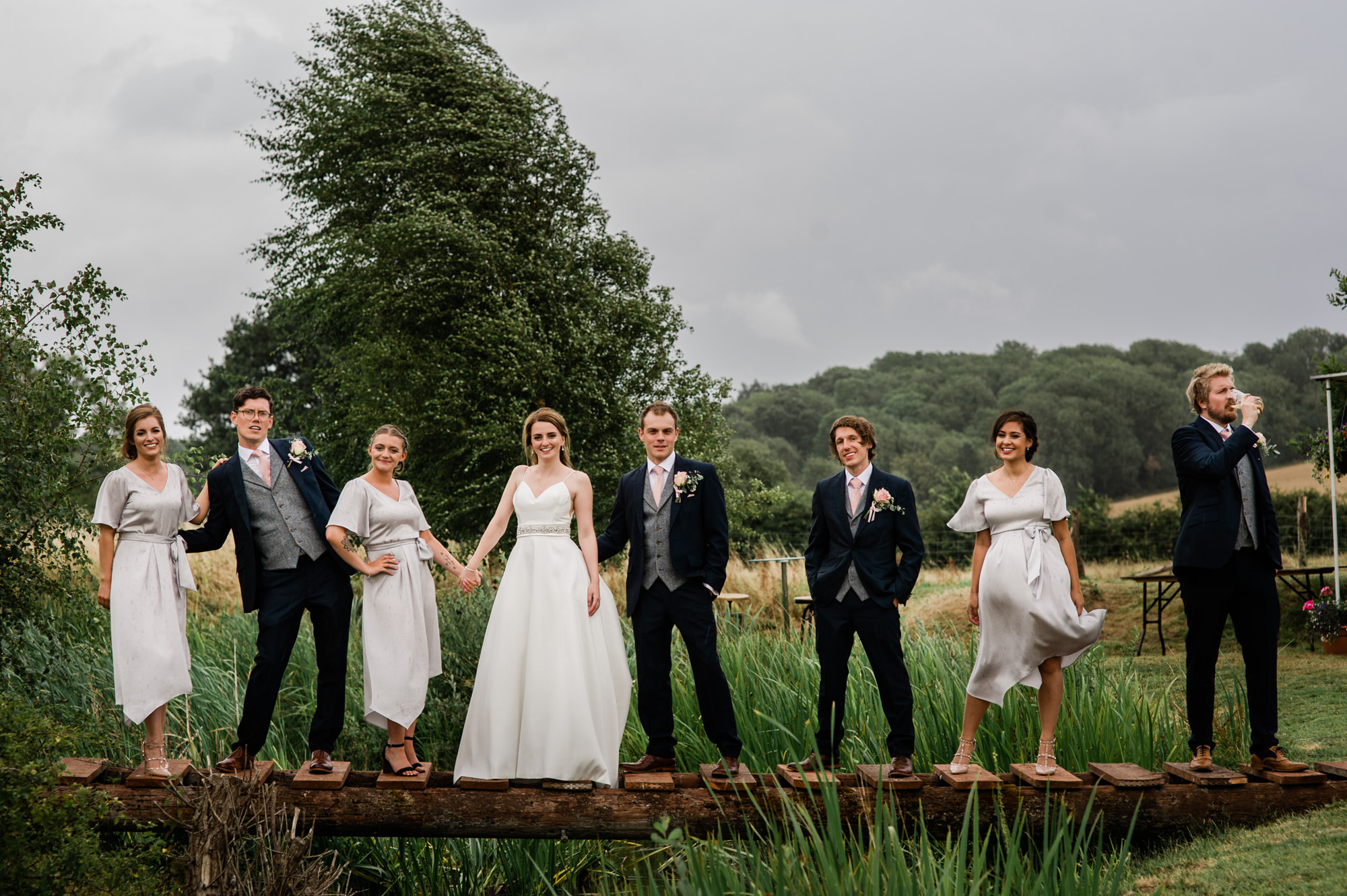 Wedding party stood on a bridge in Salisbury wedding photographer