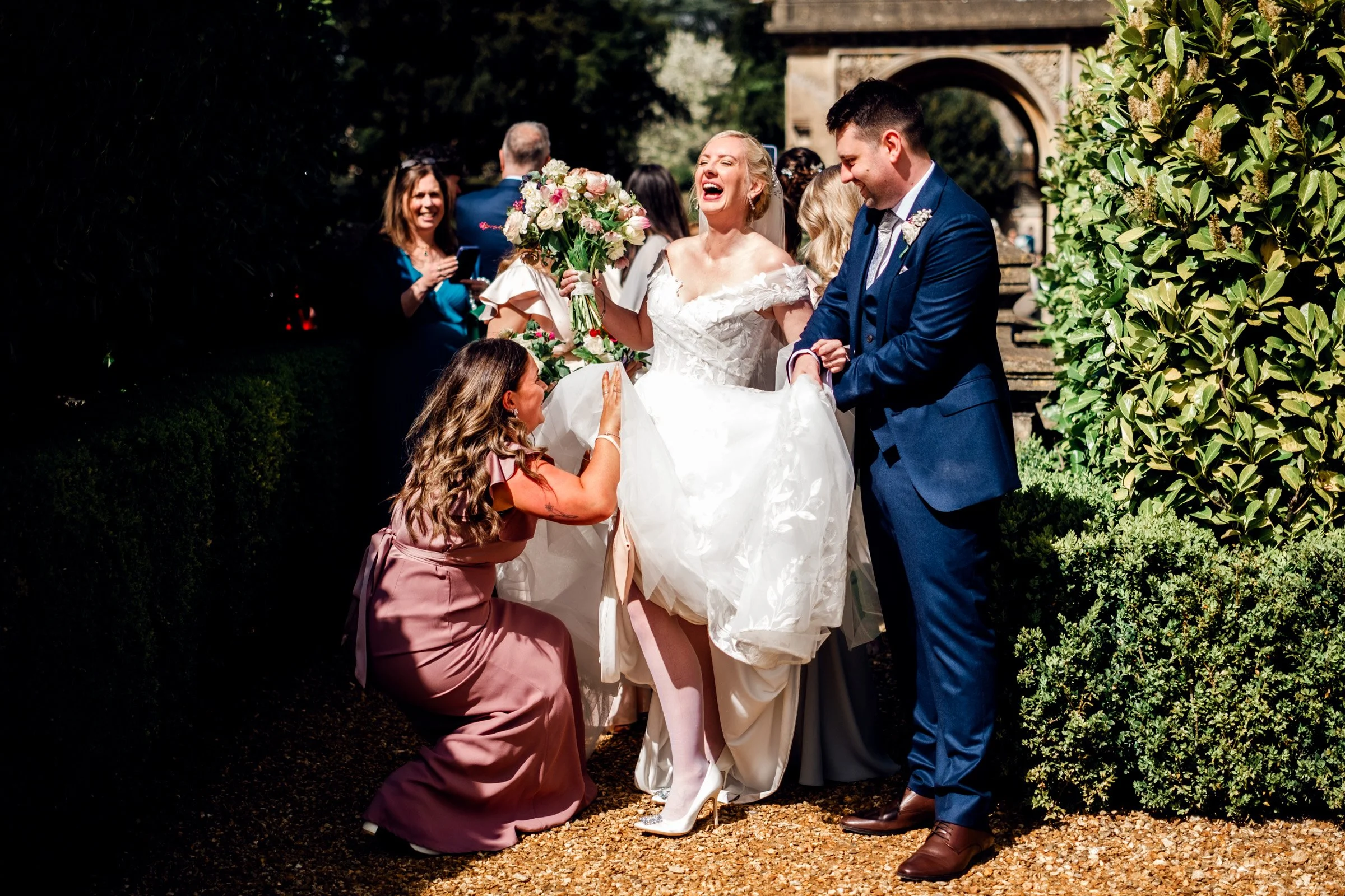 Bride laughing with bridesmaid at Grittleton House just after the church ceremony