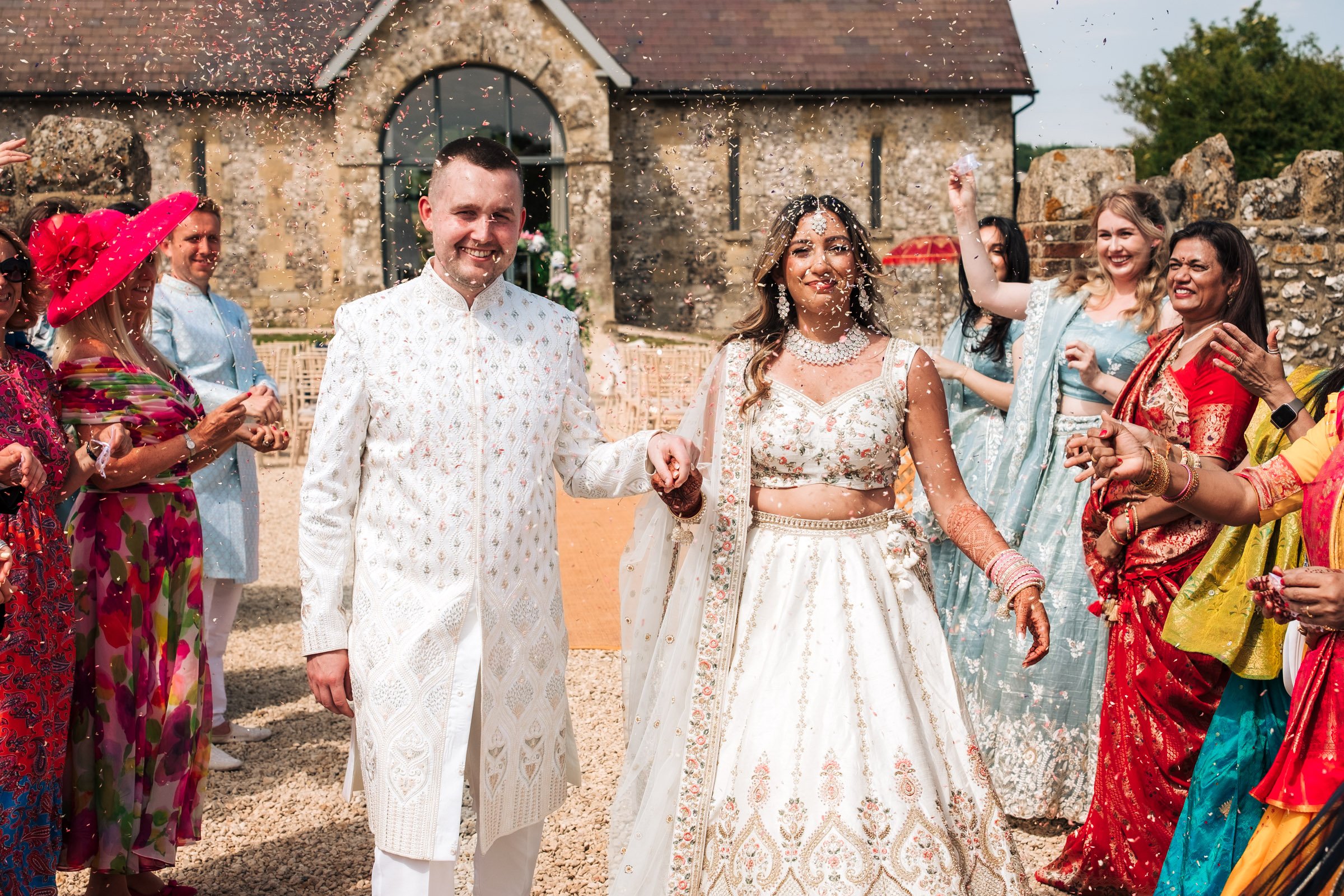 Bride and Groom walking down confetti line at Bake Barn weddings