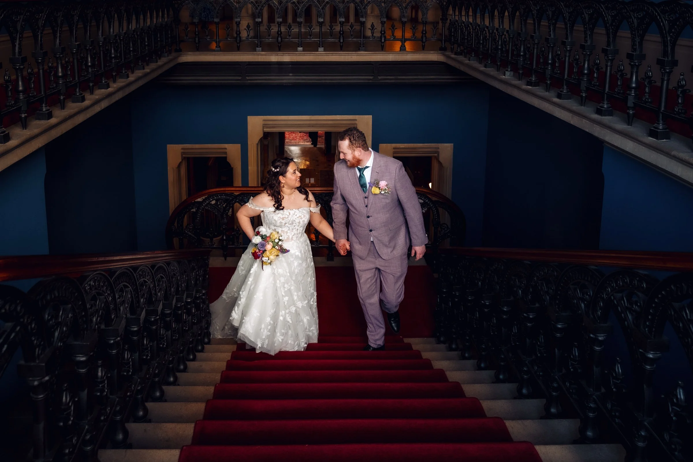 Ellie and Issac share a moment while walking up the grand stairs at Grittleton House