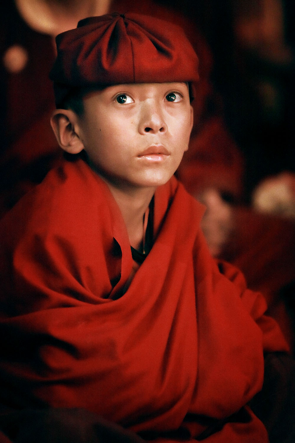 Young monk watching theatrical performance by Drukpa nuns, Hemis Monastery