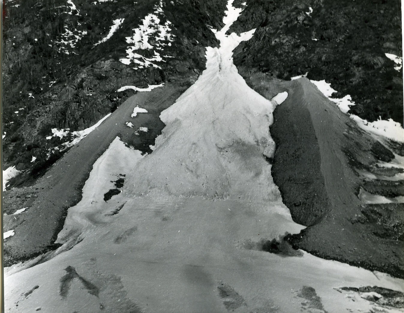 PSA. 36 Avalanche path Tupper 2 with confining dikes and avalanche deposit prior to construction of snowshed. Spring 1960