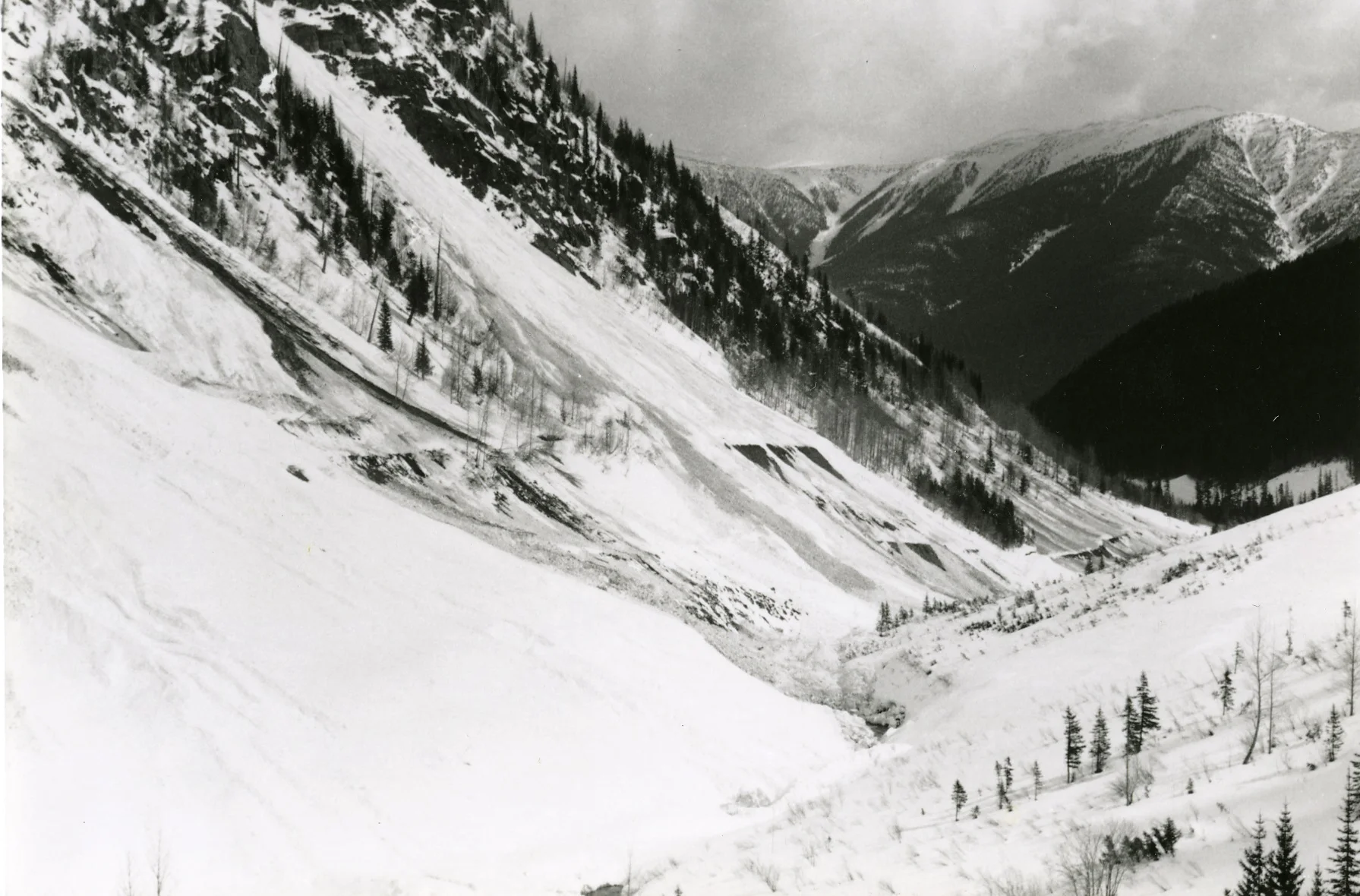PSA.78 Tupper 1 and 2 Avalanche paths. Old railgrade, highway grade below. After major avalanche cycle. Apr. 13, 1959
