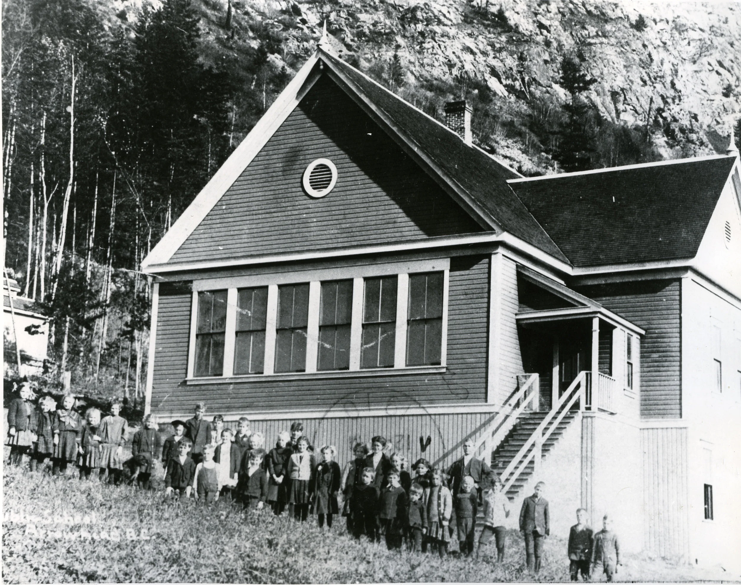 Arrowhead School with teacher J.R. Thompson next to the stairs, circa 1910. P1995