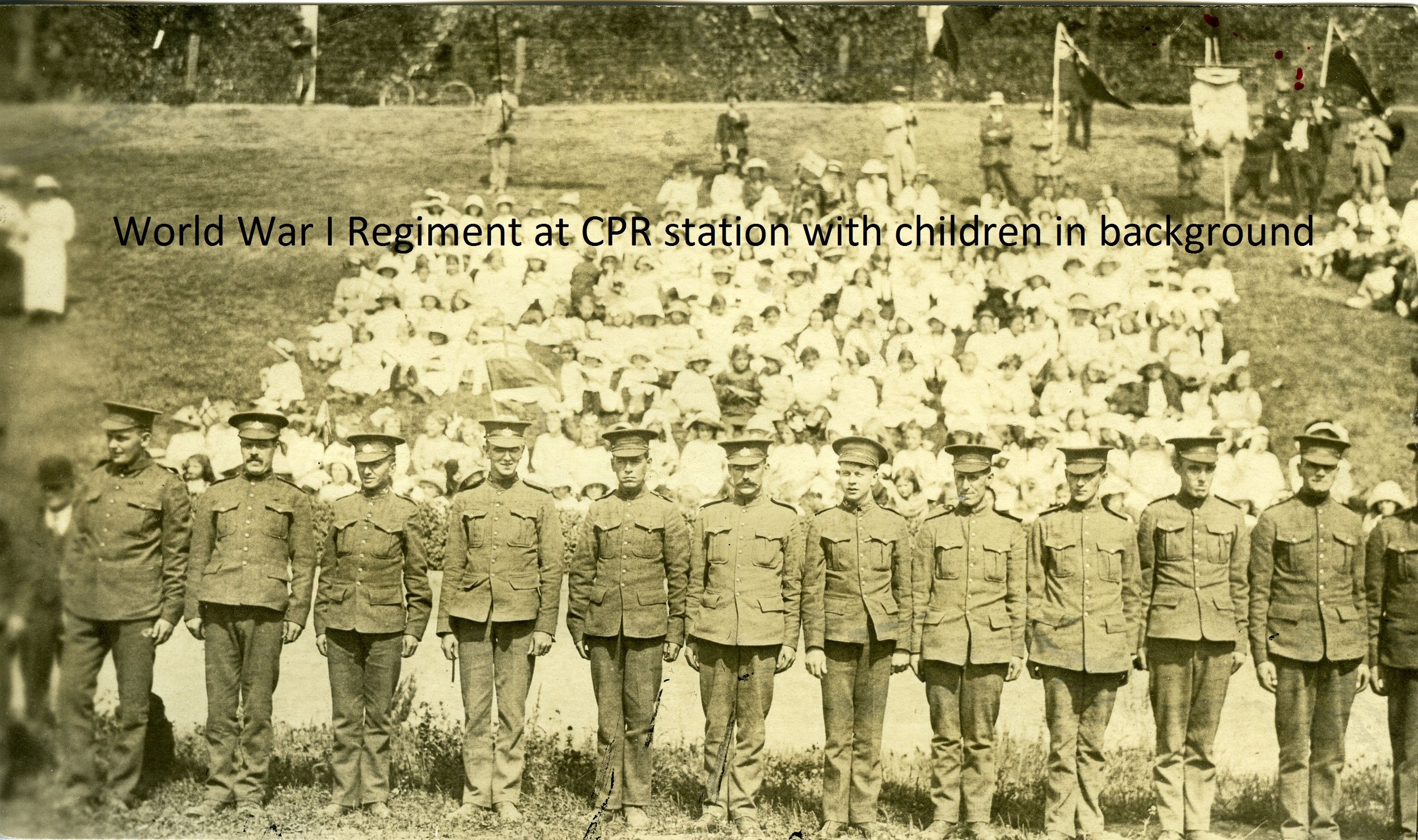 2420 World War I regiment (probably RMR) possibly at CPR station with school children in background.jpg