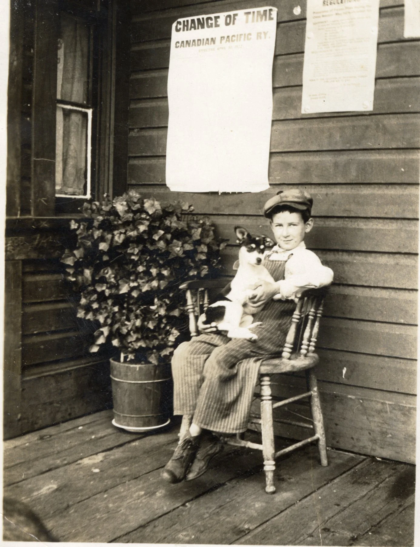 13955 Neil McLean in chair holding dog in lap, Gerrard, B.C..jpg