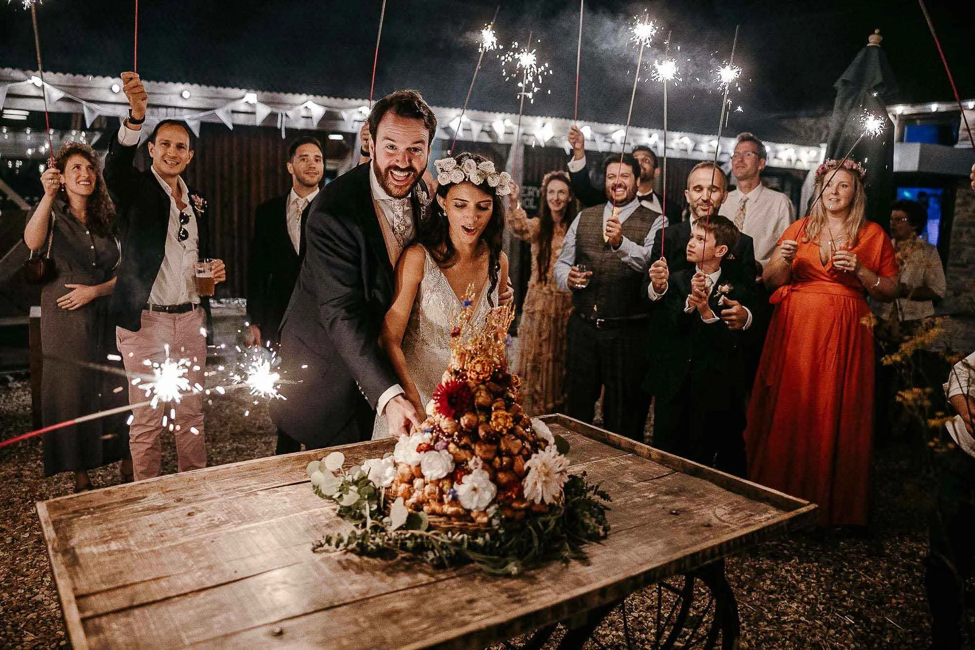 River Cottage Wedding photograph, couple cutting the cake in the courtyard