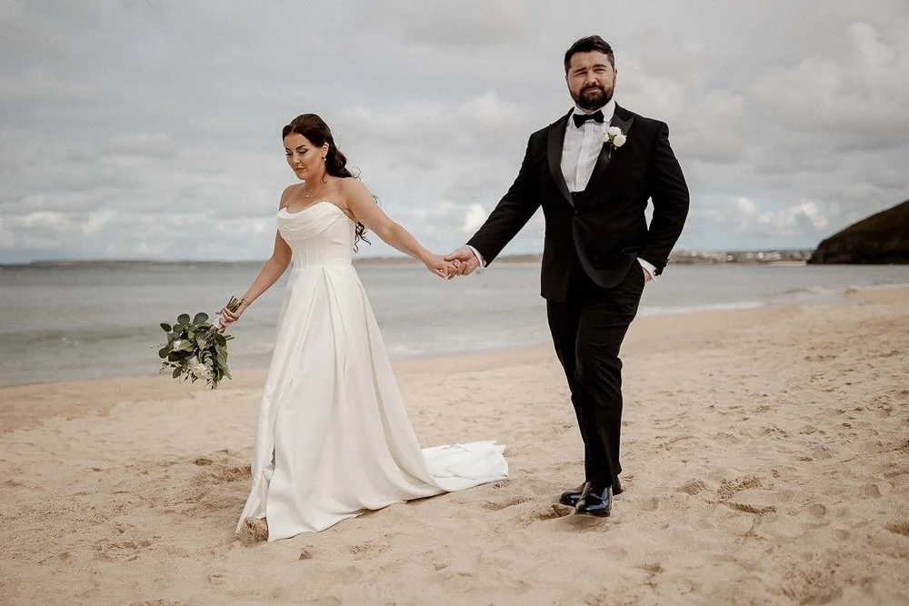 Hand in hand, no direction needed. Just the sea, the sand, and a moment that felt completely theirs. F+L at the @carbisbayweddings @carbisbayestate 

#documentaryweddingphotography #cornwallweddingphotographer #carbisbayhotelwedding