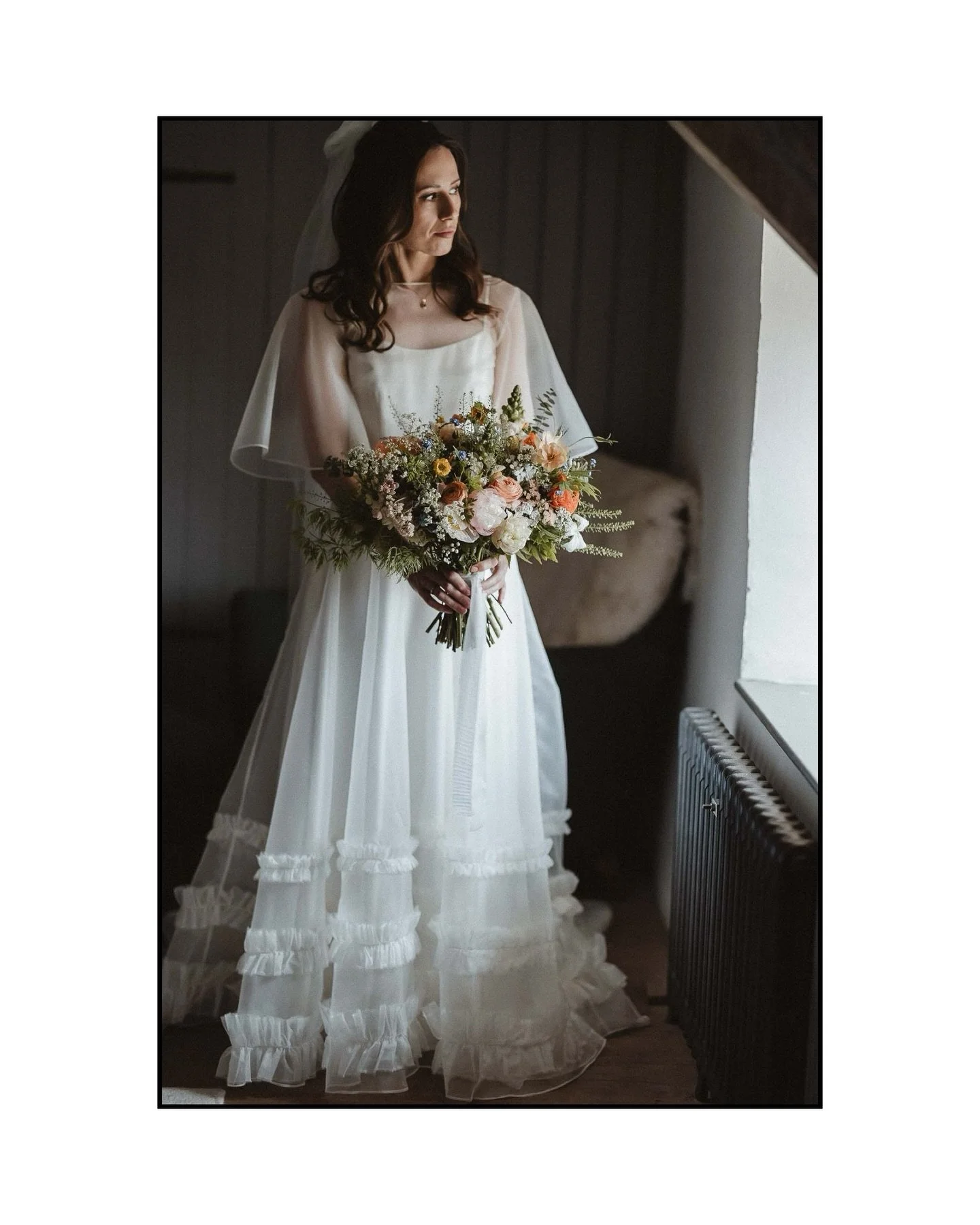 Love this one.

A quiet moment, just before everything begins.

No big pose. No performance.
Just B, stood by the window at River Cottage, bouquet in hand, light falling softly across her dress.

These are the frames I&rsquo;m drawn to.
The in-betwee