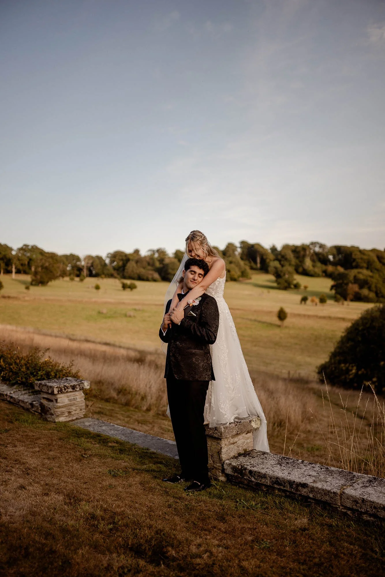 Couple enjoying sunset on their wedding day at Boconnoc estate