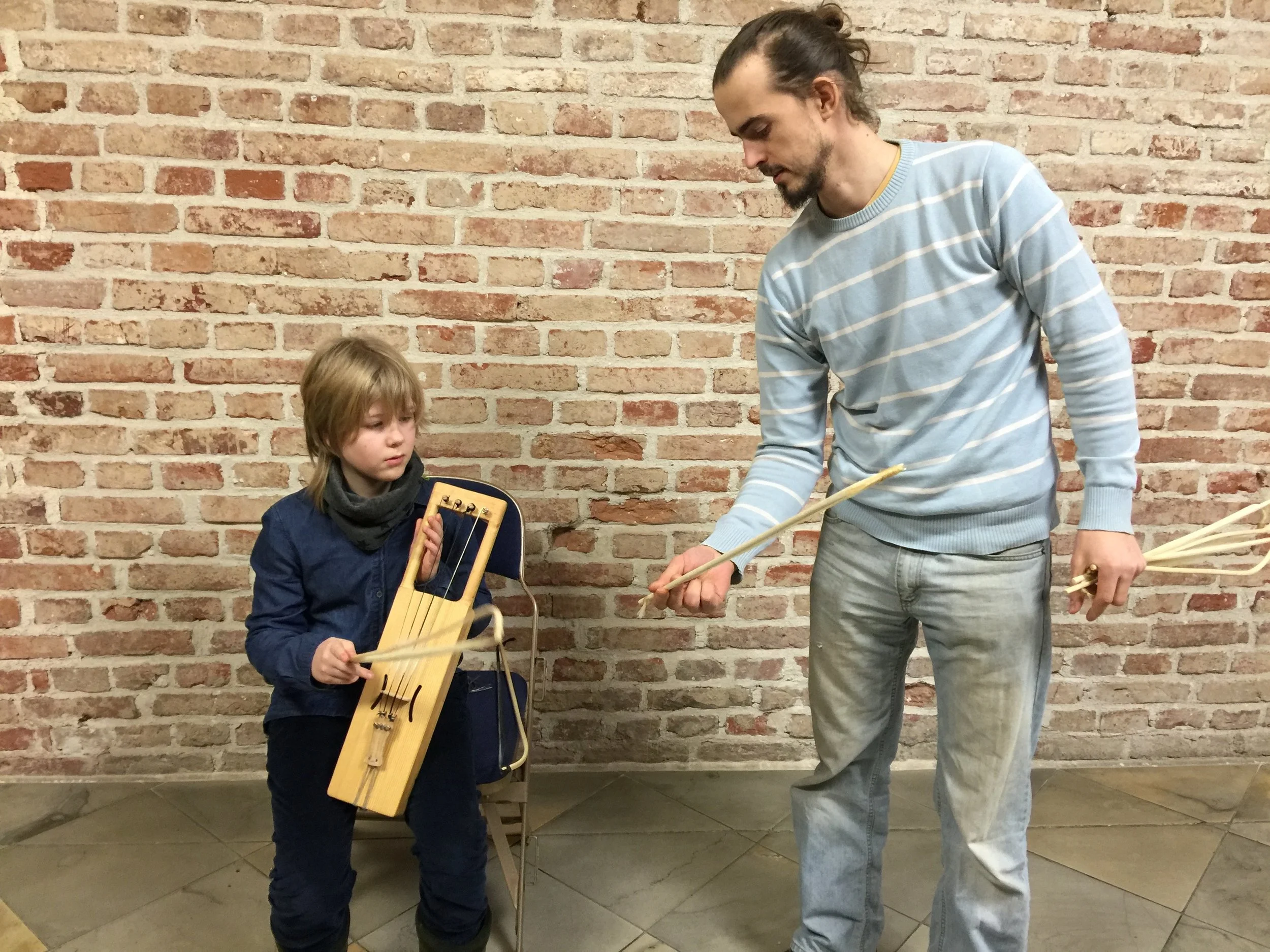 The new harp with its maker Mihkel Soon and my son.