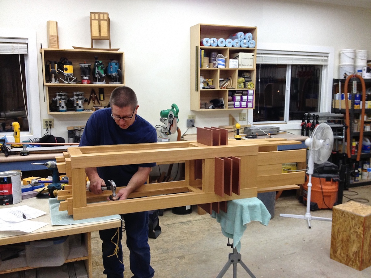 ​Todd Clippinger assembles electrical wiring inside the prairie chandelier in preparation for the fine woodworking exhibition at the Museum of the Rockies