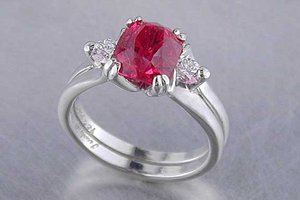cushion shaped red spinel with trillion diamond sides set in recycled platinum