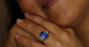 emerald cut blue sapphire trapezoid diamond partial bezel engagement ring