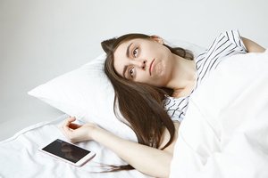 tired young woman fed up with phone