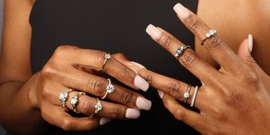 model wearing multiple styles of engagement rings