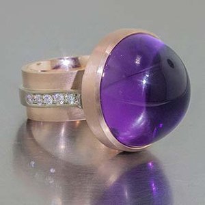 rose gold ring with amethyst and diamonds set in a white gold channel