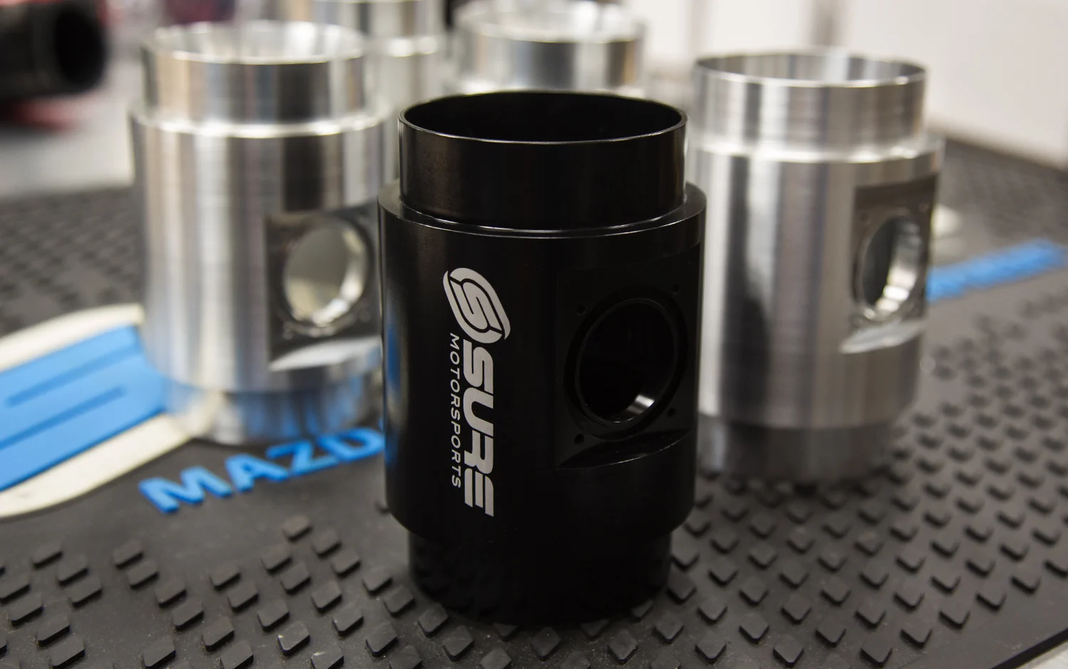 MAF housings before and after the anodizing process. Along with the high quality finish, anodizing increases oxidation resistance.