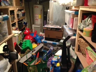 This was once a lovely room of neatly shelved storage items. Now it's where we try to fit more of things we're trying to hide from view.