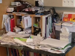 This is always like this. It's where the papers go. They may fly off the desk as the kids run by, but we just put them back up there. Twice a year, we get to the bottom of this mess and vow it will never look like this again.