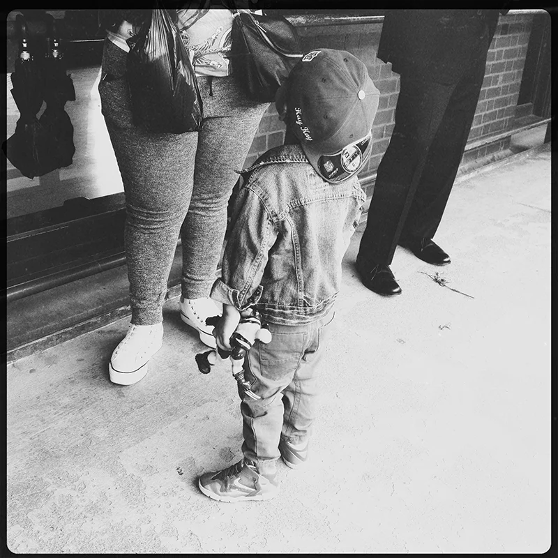 A well dressed kid on the train platform
