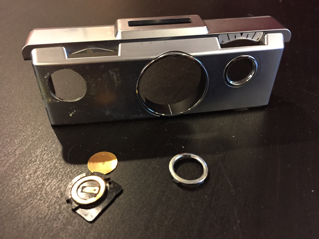 The old front plate. Pretty clear that all of the shutter button was broken.