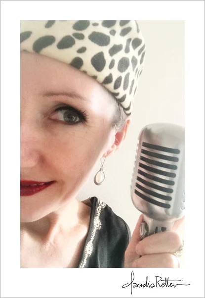 Claudia with pillbox had and Elvis mic