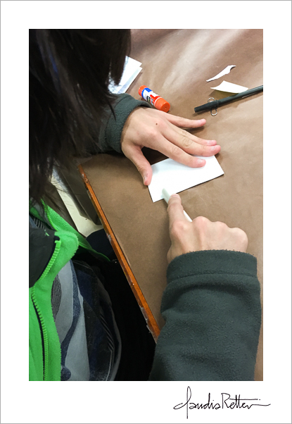 A student using a bone folder.