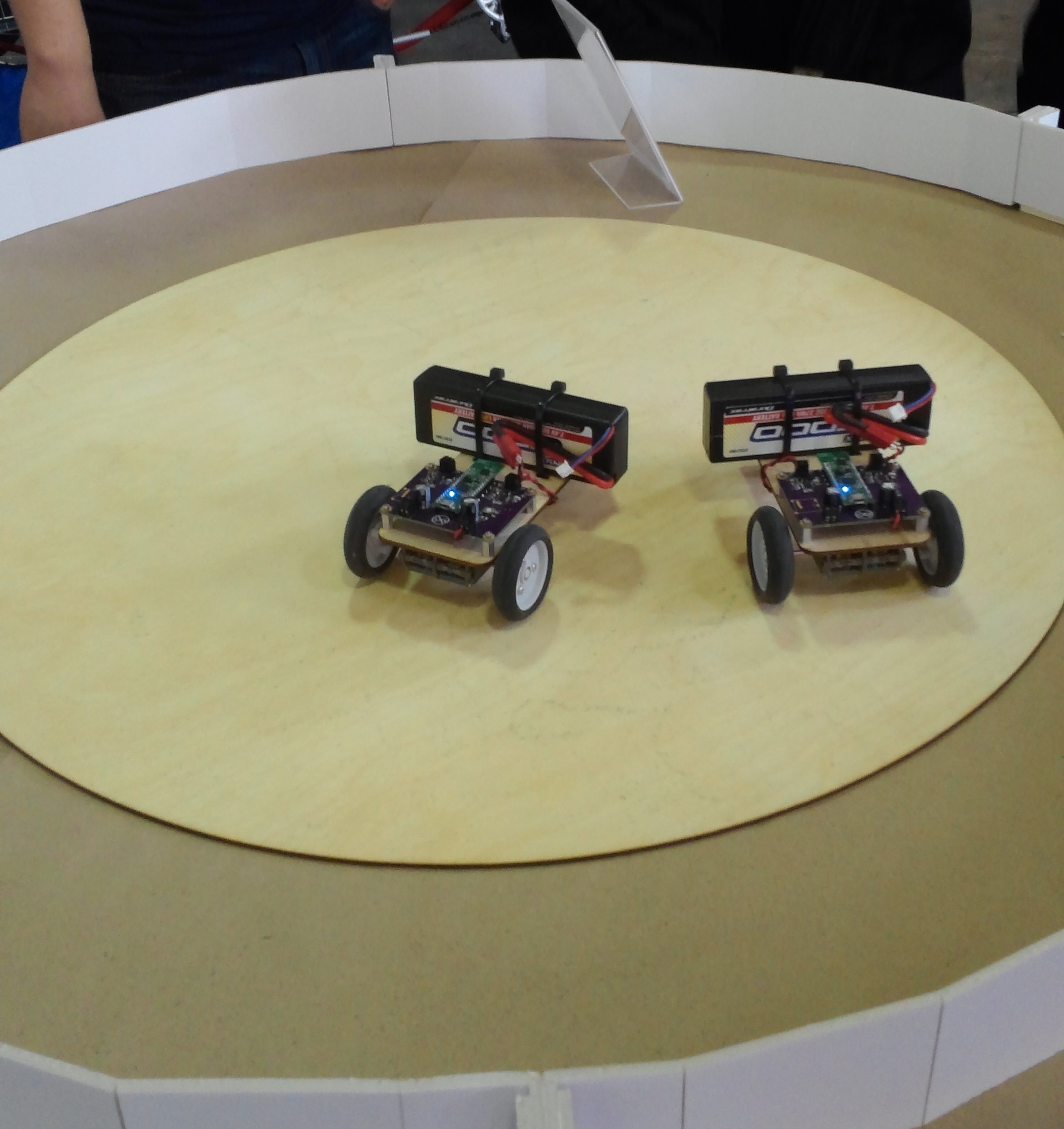The Arachnio sumo bots on the play field, ready for action! The Arachnio Dues are the green boards with blue lights. The driver boards were created for these bots, and will probably appear in the Kickstarter as a stretch goal.