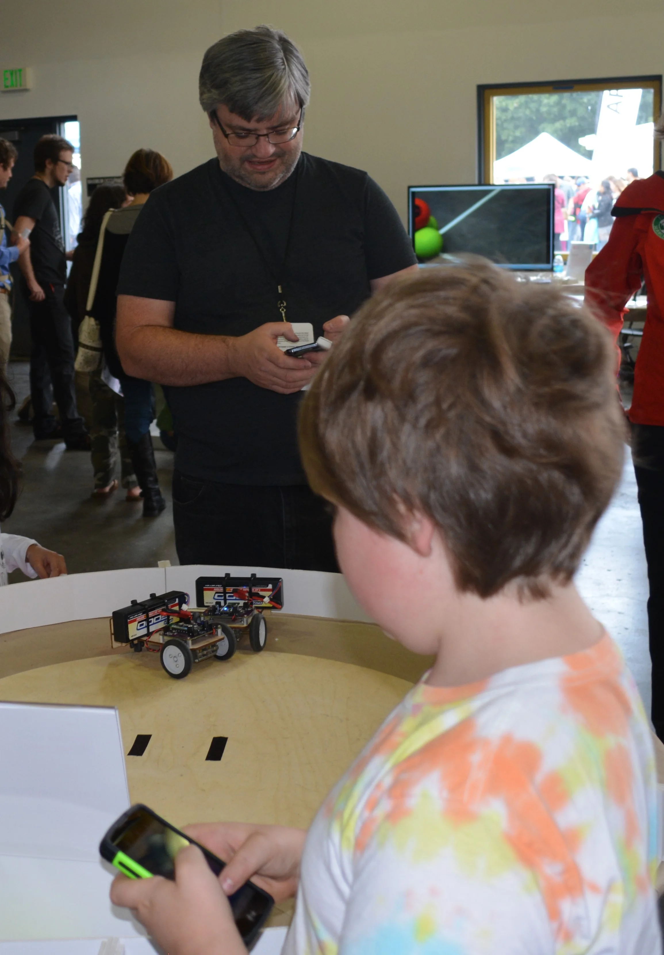 My son pushes my bot out of the ring.
