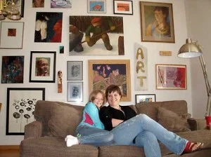 Anastahja Steadman, left, and her mother, Heidi Jeub, sit in front of a wall of eclectic art.